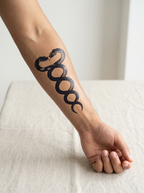 Tatouage Serpents Jumeaux appliqué sur avant-bras